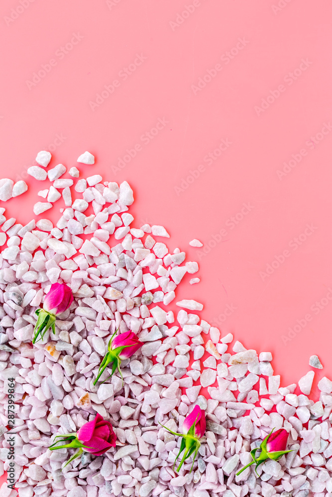 decorative pebble and roses mock-up for design on pink background top view