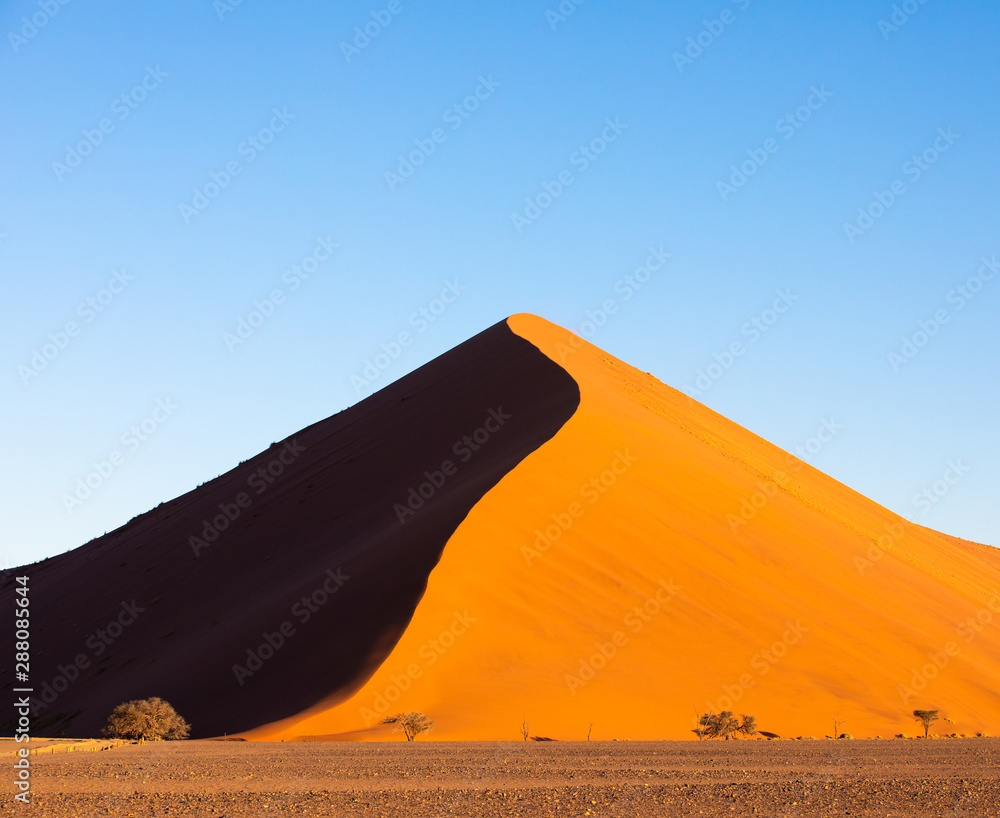 Deep colors of sand dunes during sunset. Sossusvlei, Namibia.