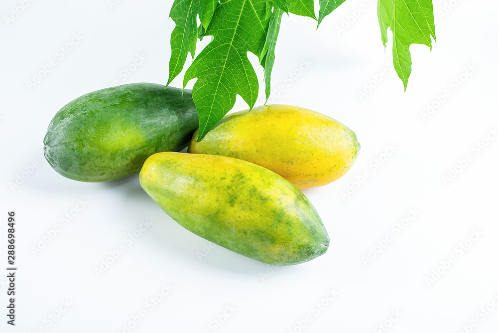 Fresh papaya and papaya leaves on white background