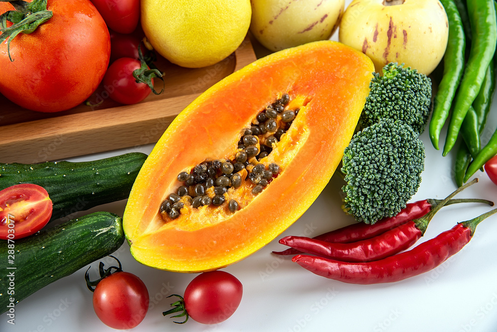 Fresh seasonal fruits and vegetables and papaya close-up