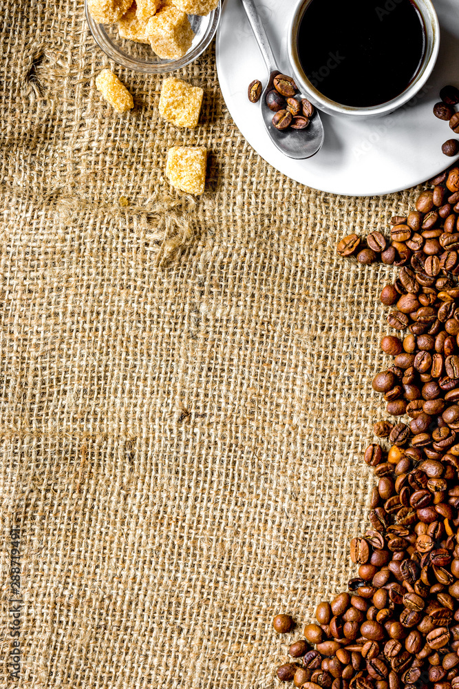 coffee beans, coffe cup on linen cloth background top view