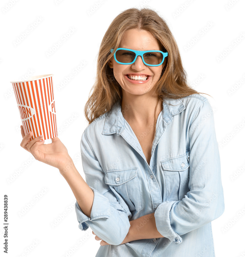 Young woman with popcorn watching movie on white background