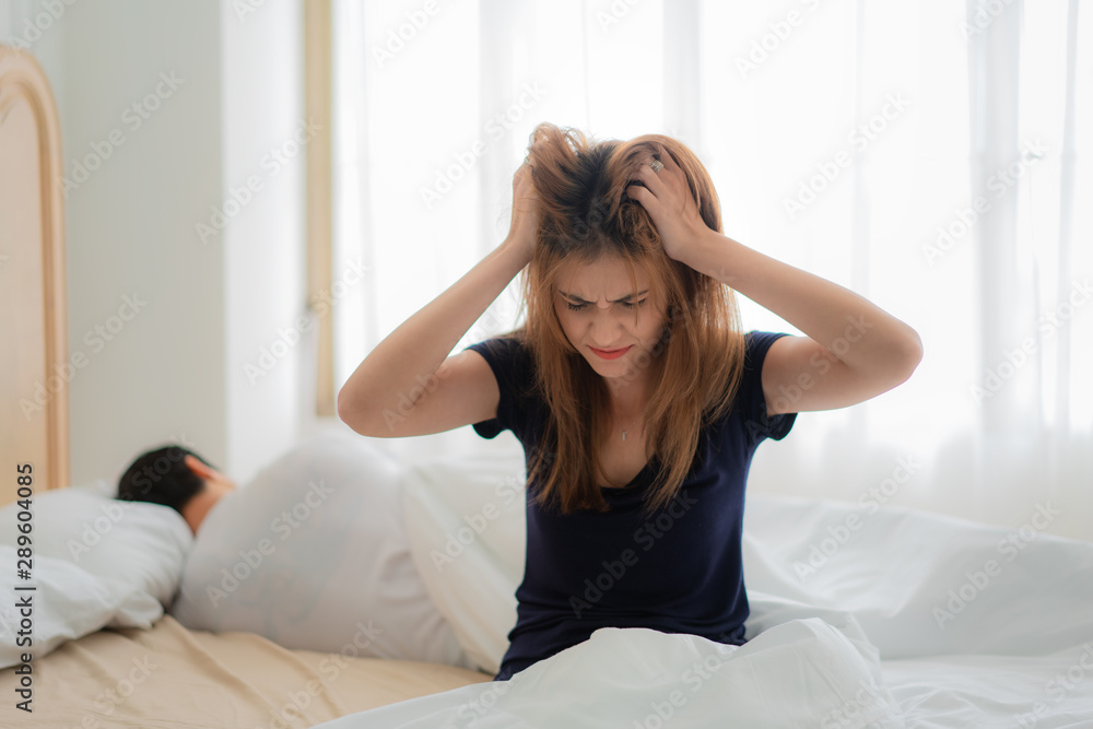 Unhappy couple not talking after an argument in bed at home. People, relationship difficulties and f