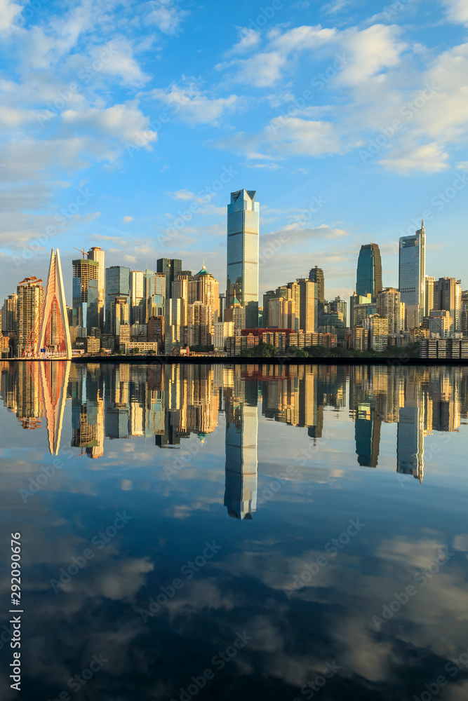 Chongqing skyline and modern urban skyscrapers with water reflection at sunset,China.