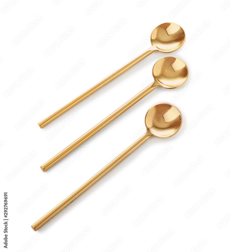 Golden spoons on white background