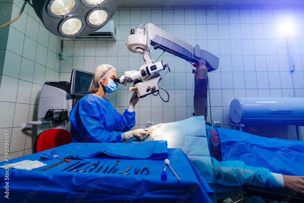 Surgeon with operating system of laser vision correction in the operating room. Ophthalmology operat