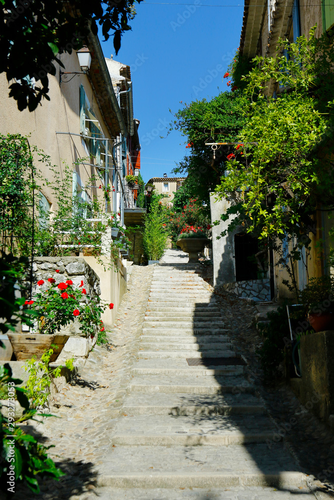 street and stairs of mediterranean village with stone wall
