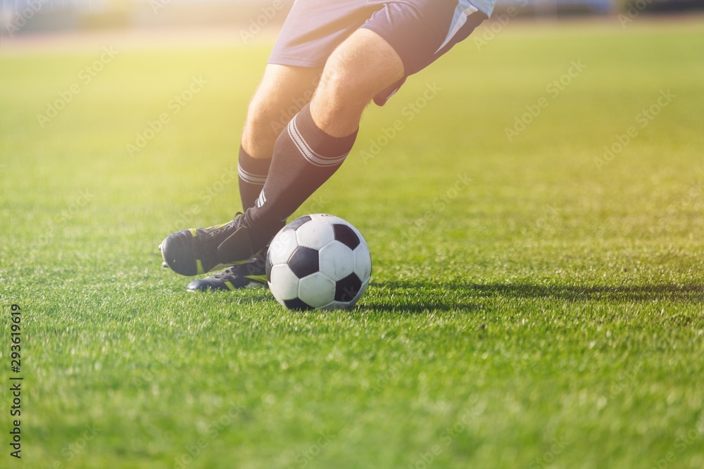 Running soccer player on grass