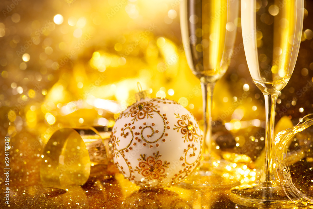 Holiday Champagne Flute over Golden glow background. Christmas and New Year celebration. Two Flutes 