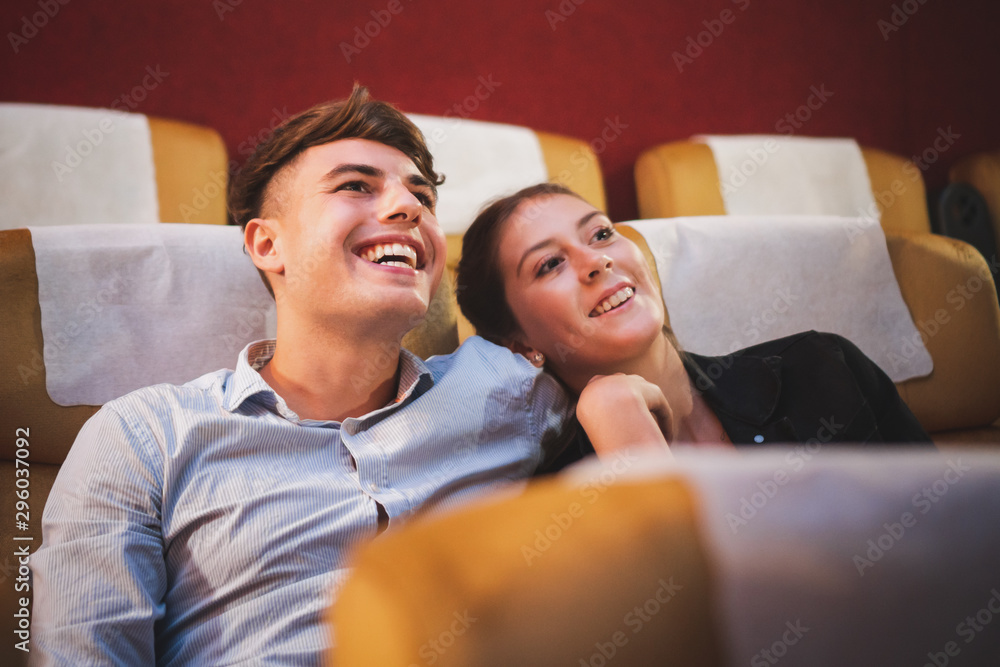 快乐的年轻情侣在影院/影院看电影