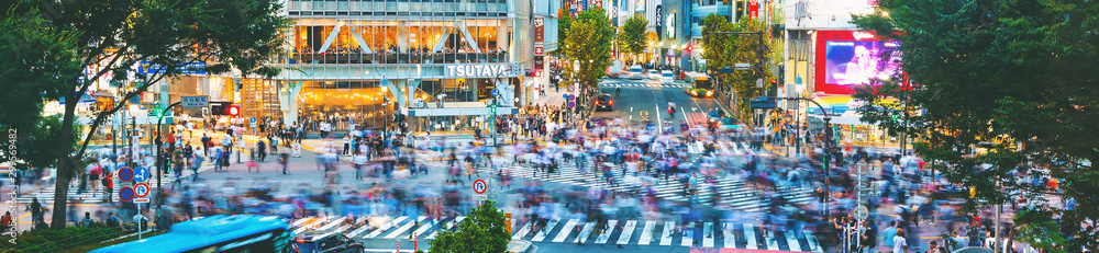 People cross the famous intersection in Shibuya, Tokyo, Japan one of the busiest crosswalks in the w