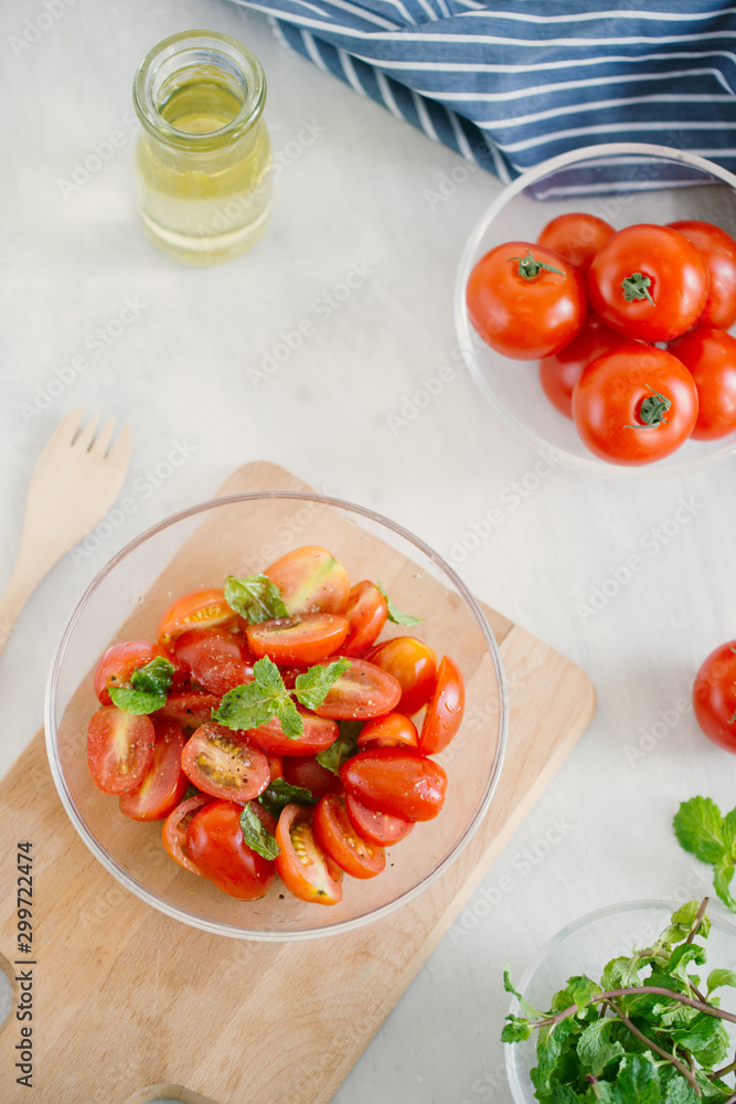 Fresh delicious salad with tomatoes. Doing fresh green salad