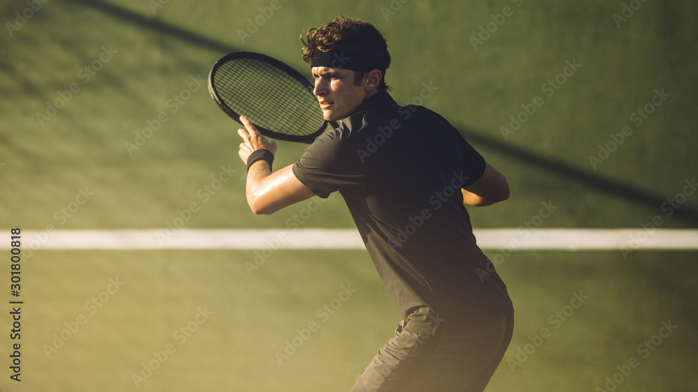 Young player playing tennis on hard court