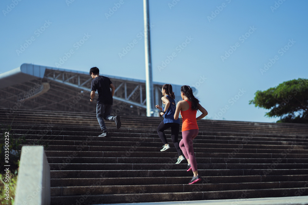 Asian friends group jogging up the stairs