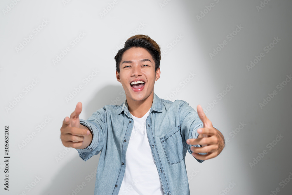 Asian cheerful excited men friends wearing jeans t-shirt standing isolated over white background, sh