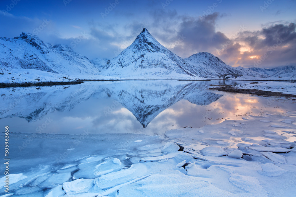 Mountain reflected in a fjord in Norway in winter
