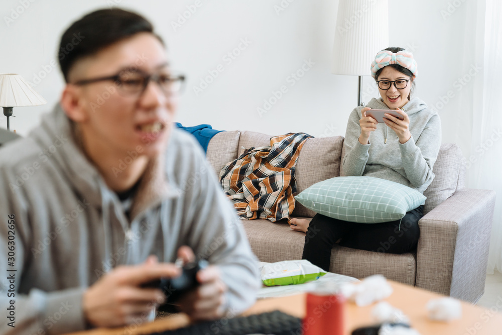 Happy couple having fun in themselves at home. bokeh view of young man playing video online games on