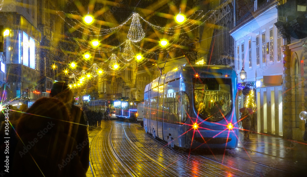 CLOSE UP: Glaring Christmas lights illuminate the festive city streets at night