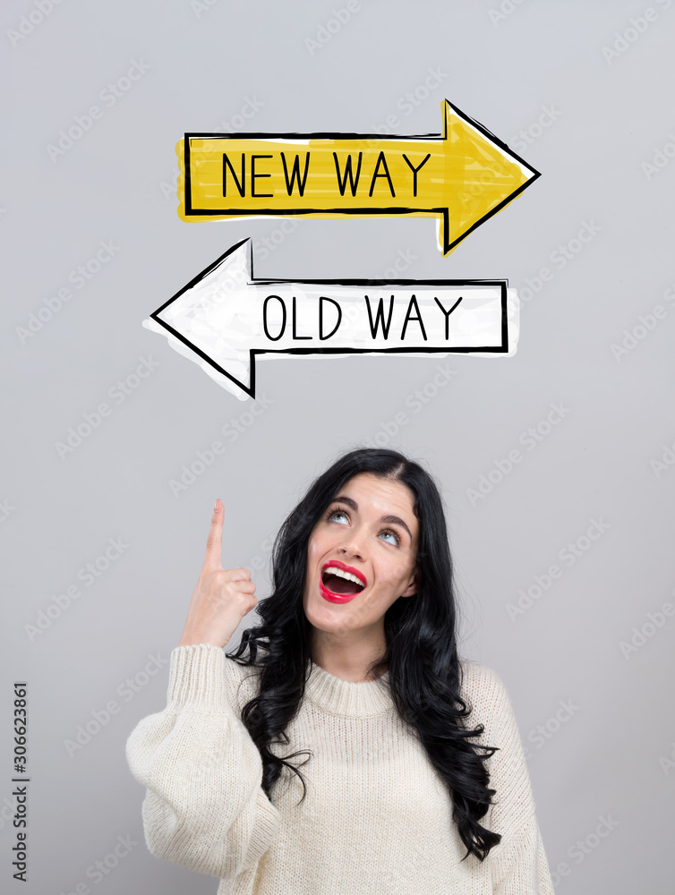 Old way or new way with happy young woman on a gray background