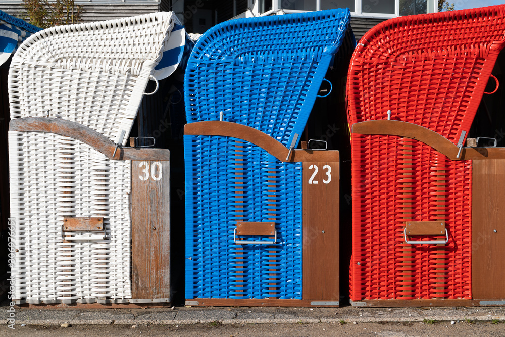A row of colorful beach chairs waiting for the summer