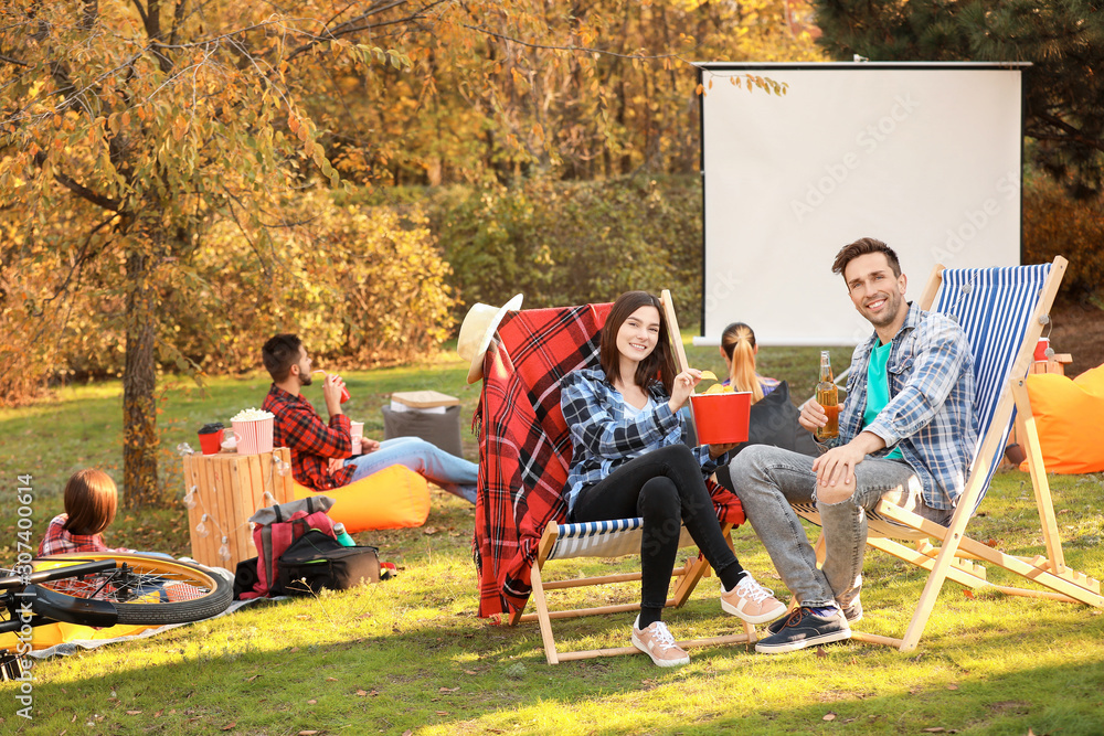 Happy young couple in outdoor cinema