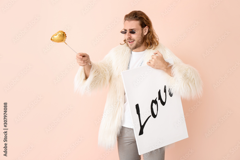 Stylish man with heart and picture on color background. Valentines Day celebration