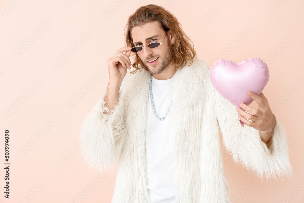 Stylish man with heart on color background. Valentines Day celebration