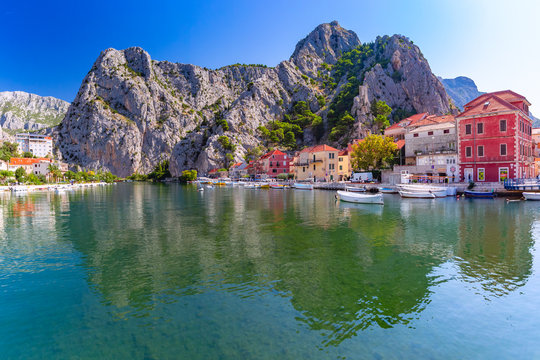 Sunny beautiful view of Cetina river, mountains and Old town in Omis, very popular tourist spot in C