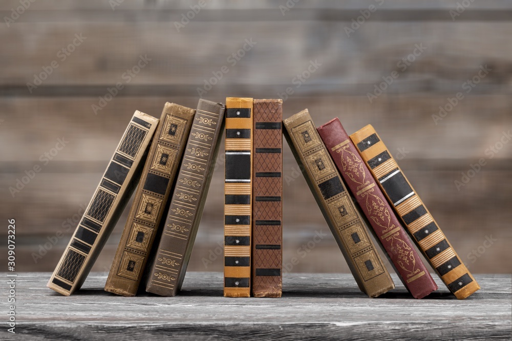 Retro old stack books on wooden desk
