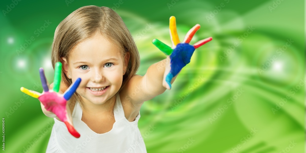 Little happy girl with colorful painted hands-on abstract background