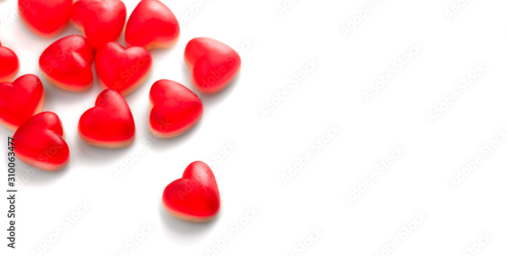 Heart shaped jelly candy, love background. Red jelly sweets candies on white backdrop. St. Valentine