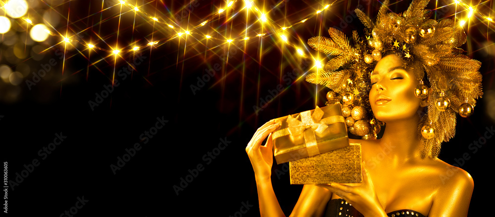 Christmas golden Woman. Winter girl receiving gift, opening magic box,  Beautiful New Year, Christma