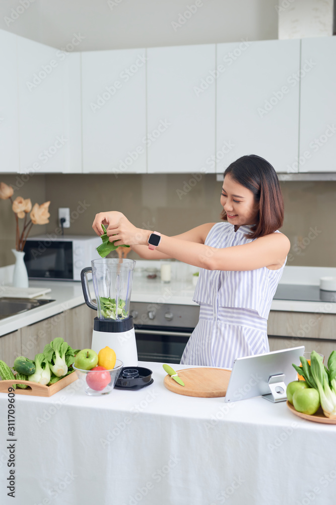 健康的亚洲女性喜欢做绿色蔬菜排毒清洁剂和绿色水果冰沙配果汁