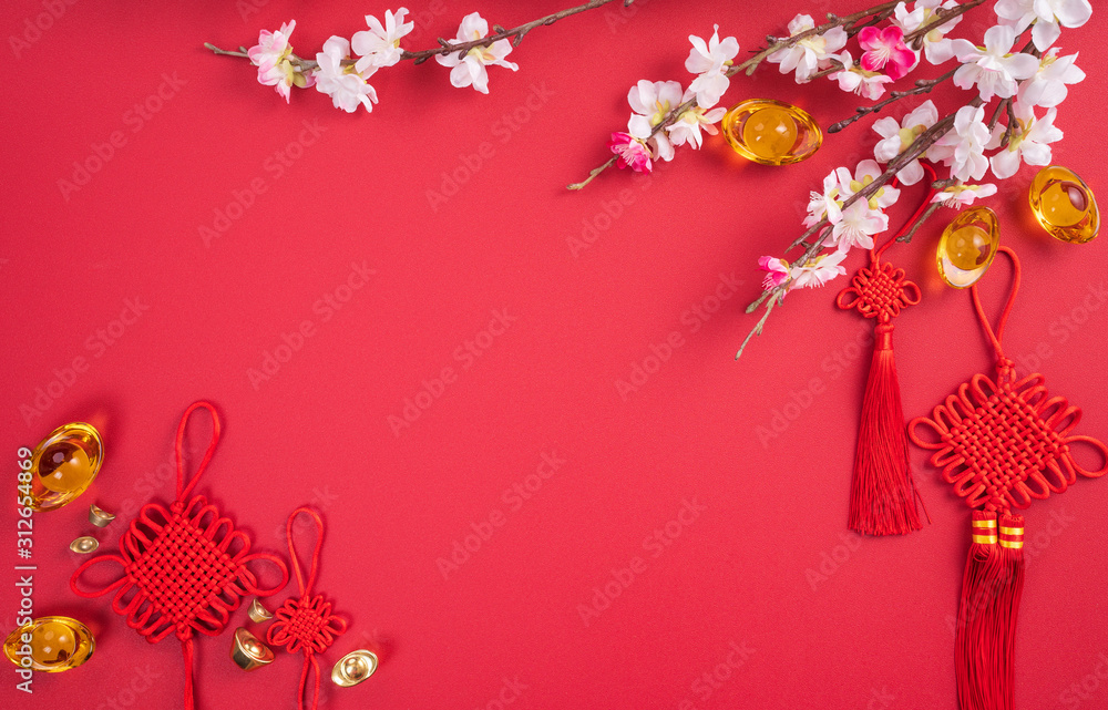 Design concept of Chinese lunar new year - Beautiful Chinese knot with plum blossom isolated on red 