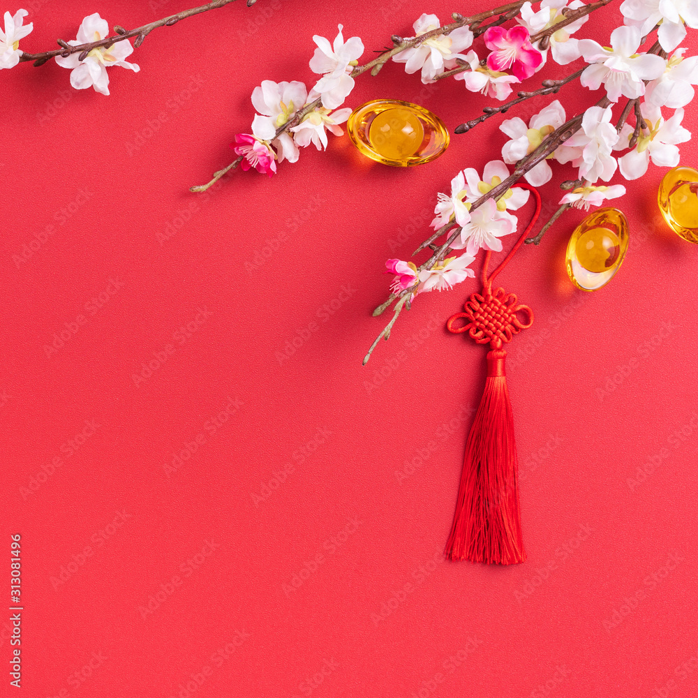 Design concept of Chinese lunar new year - Beautiful Chinese knot with plum blossom isolated on red 