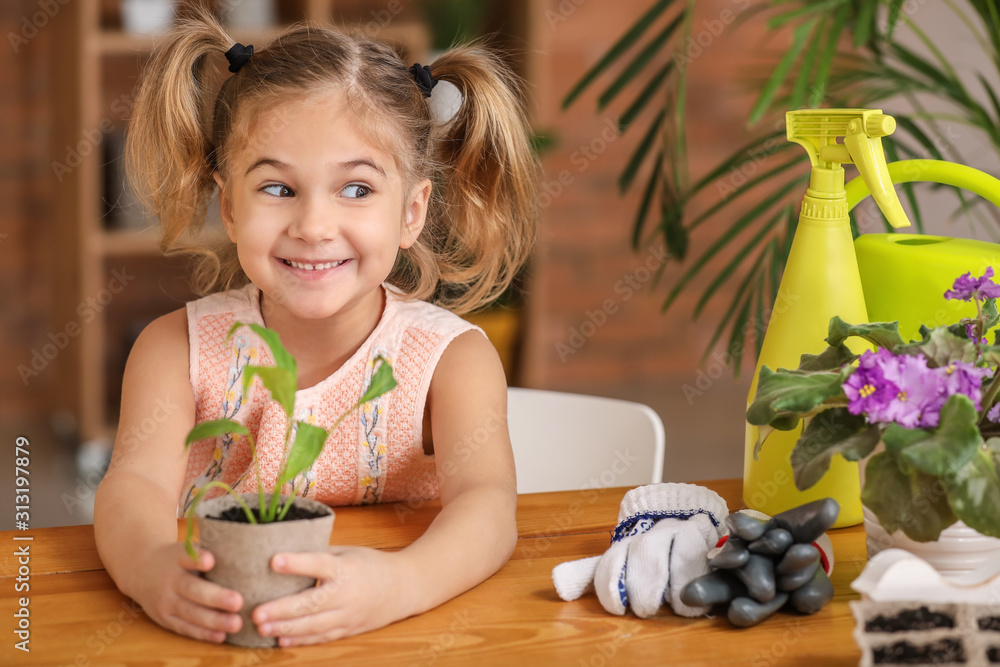 家里盆栽着小植物的快乐小女孩