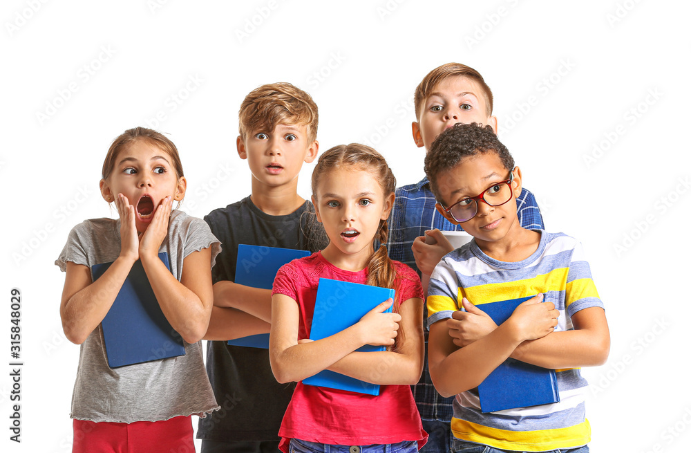 Surprised little children with books on white background