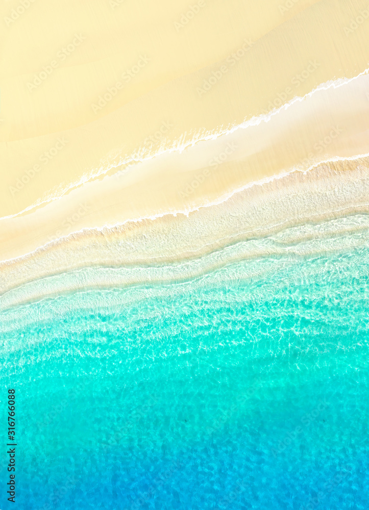 Natural textured summer background for vacation. White golden sand on the beach and turquoise water 