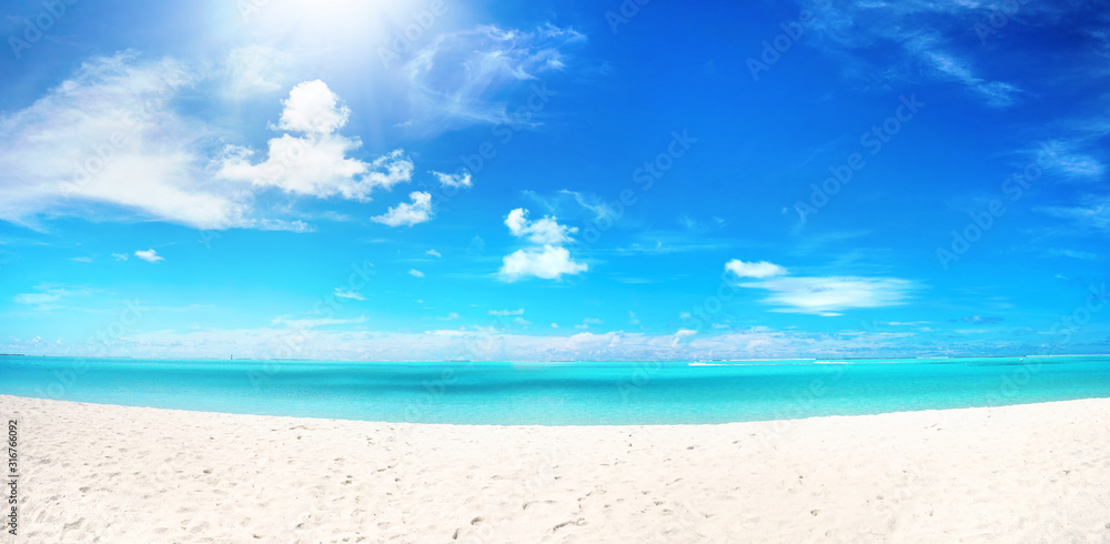 Beautiful beach with white sand, turquoise ocean water and blue sky with clouds in sunny day. Panora