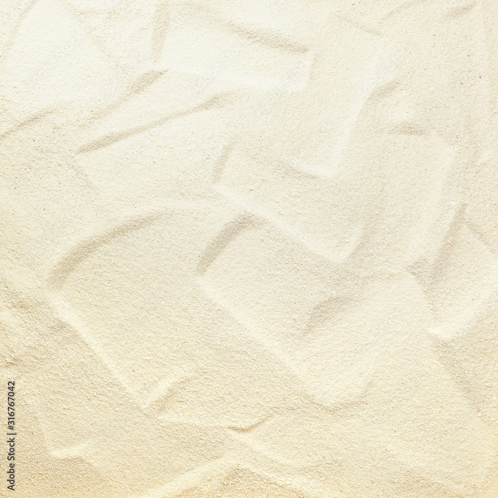 Natural background - beautiful texture of fine white beach sand with a Golden sheen close-up.