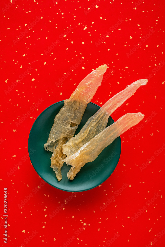 A plate of golden yellow mucilan caramel on a red background