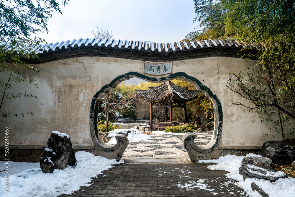 Beijing Botanical Garden Jixiu Garden after clear winter snow. Chinese translation on the Moon Gate: