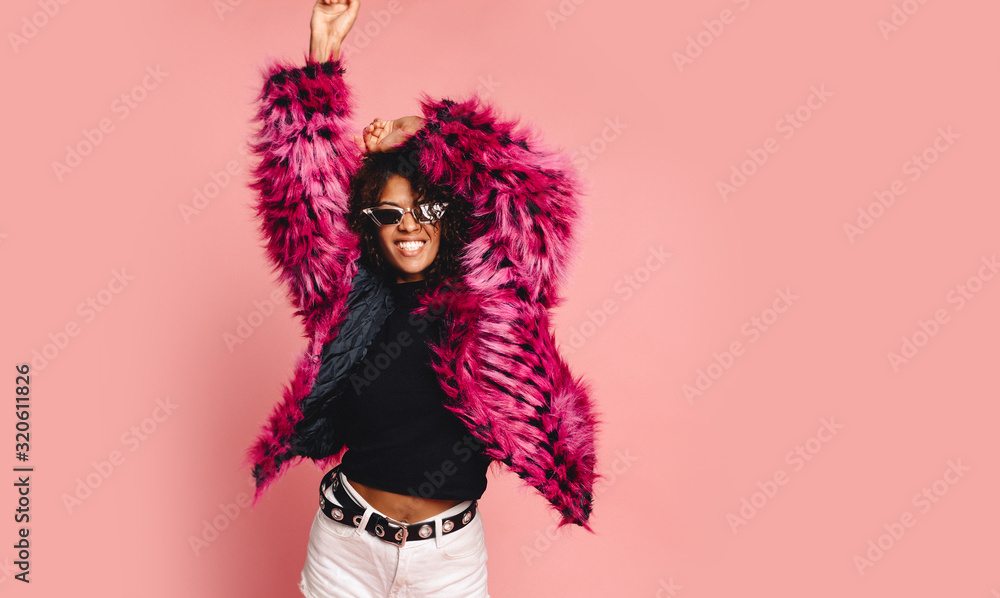 Black woman in a black faux fur jacket, Close up fashion portrait of crazy hipster African girl with