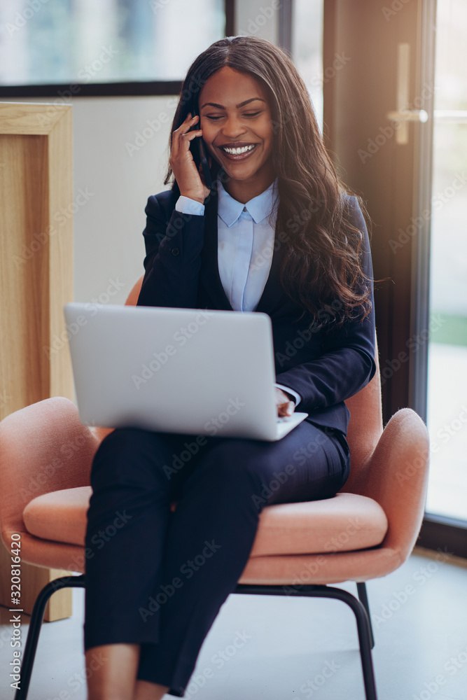 Smiling African America businesswoman working and talking on her