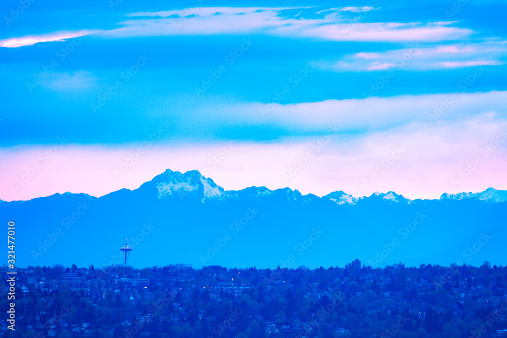 View of Seattle town at dusk and mountain peak of Olympus on background with homes from Bellevue, Wa