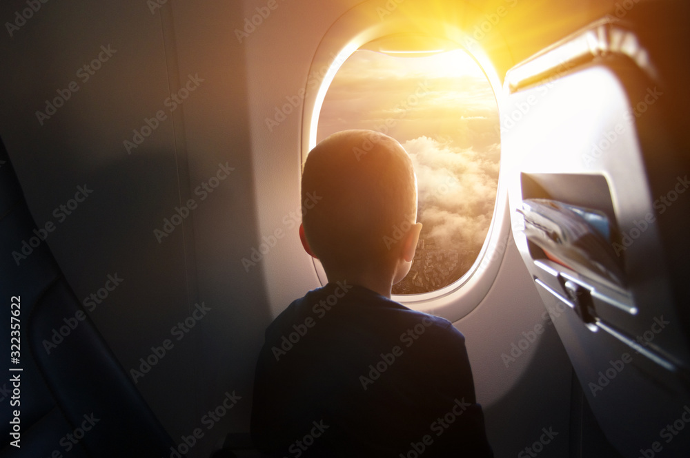 Boy in the plane looking out the window