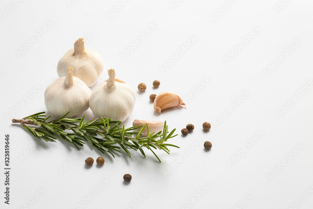Garlic, spices and herbs on white background