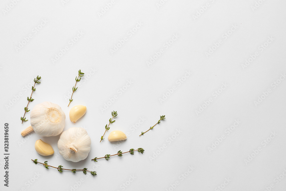 Garlic and herbs on white background