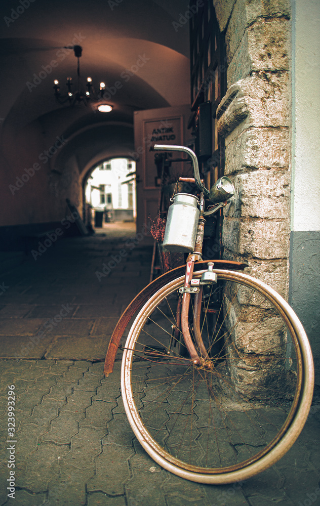 Old bicycle on entrance to old town backyard in Tallinn, Estonia
