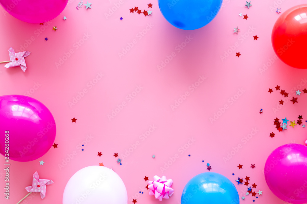 Party concept. Colorful balloons and confetti on pink background top-down frame copy space
